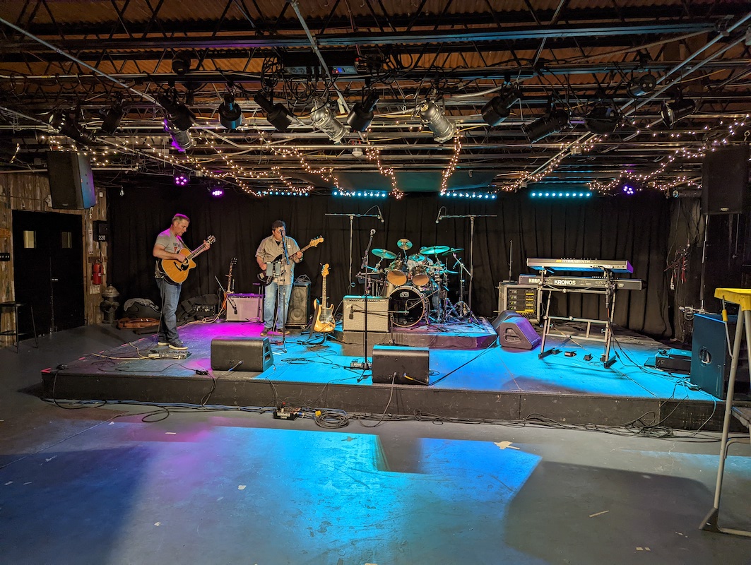 Nate and Alex setting up their gear on stage